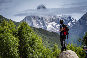 hiker in front of the Yaomei Feng summit, 6250 m. Haizigou Valley, Mount Siguniang National Park, Qionglai Mountains, Sichuan,  China