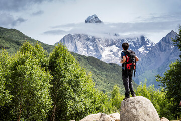 hiker in front of the Yaomei Feng summit, 6250 m. Haizigou Valley, Mount Siguniang National Park, Qionglai Mountains, Sichuan,  China