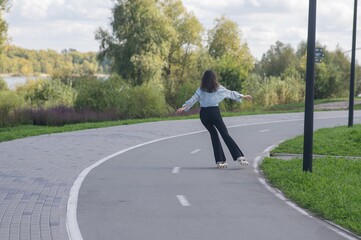 Caucasian woman roller skating in park. 