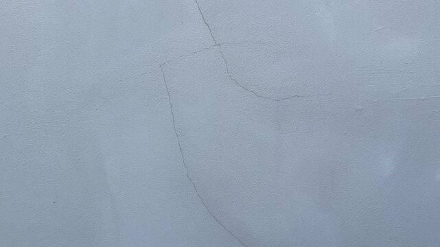 Close-up video of cracked concrete wall texture with rough aged surface details
