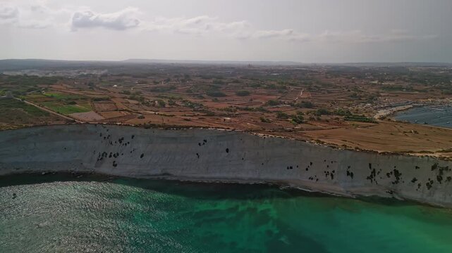 Circular aerial hyperlapse from Munxar Hill with the gorgeous Mediterranean coastline and landscape around in Malta.