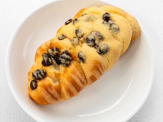 Raisin Bread on white plate, traditional cake breakfast food.