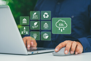 ESG concept, Businessman using digital interface on laptop with environmental, social, and governance icons, sustainability strategy, corporate responsibility, carbon footprint, green business