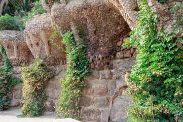 Organic stone walls and viaducts in Park Gell, overgrown with greenery