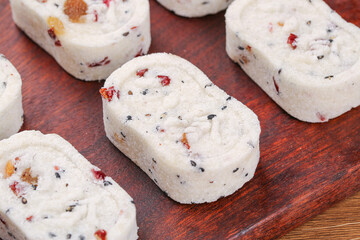 Eight Treasures Rice Cake with Nuts and Dried Fruits Traditional Asian Dessert on Wood Board