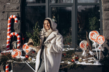 A woman walks along a city street on Christmas Eve in search of gifts and a good mood
