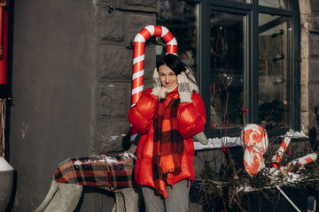 A woman walks along a city street on Christmas Eve in search of gifts and a good mood