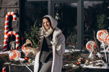 A woman walks along a city street on Christmas Eve in search of gifts and a good mood