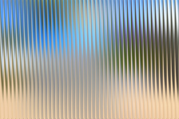 Illustration of abstract background with vertical ribbed texture and blue sky reflection