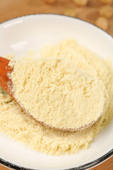 Soy Powder in Wooden Spoon - Plant-Based Protein Substitute for Vegan Cooking and Healthy Breakfast Meals