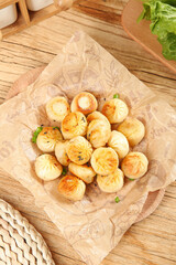 Golden Baked Buns with Herbs on Rustic Wooden Table - Delicious Breakfast Food