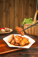 Glazed Chicken Wings with Cola Sauce on Rustic Wooden Table - Asian Style Food Photography