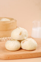 Fresh Xiaolongbao Chinese Soup Dumplings on Wooden Board with Bamboo Steamer Traditional Asian Dim Sum Breakfast