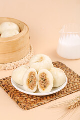 Traditional Chinese Steamed Bao Buns with Meat Filling and Bamboo Steamer Breakfast Setup
