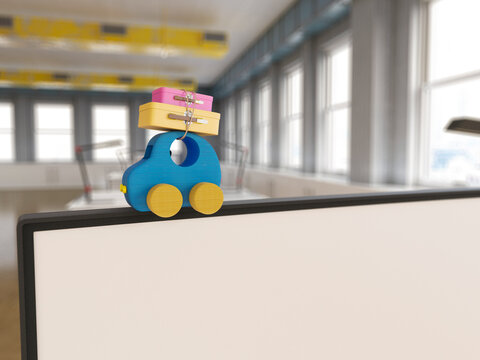 Toy car with luggage symbolizing vacation on office partition