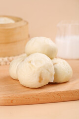 Traditional Chinese Baozi Steamed Meat Buns on Wooden Board with Bamboo Steamer
