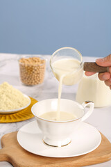 Soy Milk Alternative Drink Being Poured into Cup - Healthy Plant-Based Breakfast Beverage