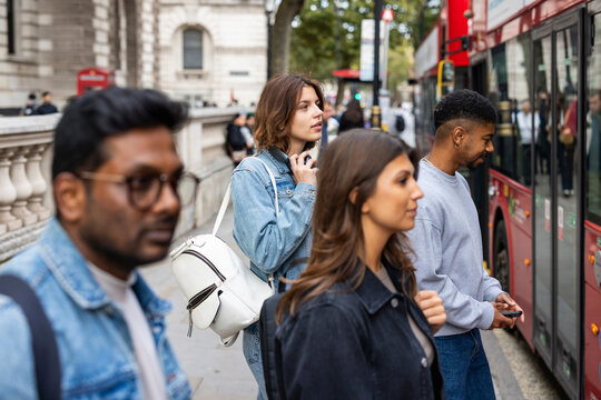 Commuters waiting for a bus in London city street