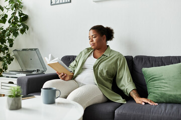 Relaxing afternoon reading in a cozy modern apartment with style and comfort