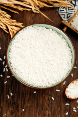White Long Grain Rice in Bowl with Wheat Stalks Studio Food Photography on Wooden Background