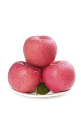 Fresh Red Apples Arranged on White Plate Against Clean White Background