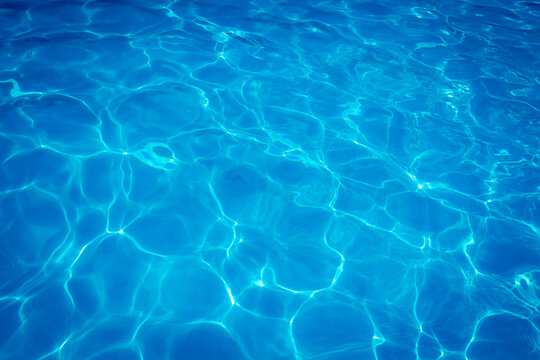 The light reflects blue in the water in the swimming pool. It looks fresh and lively, suitable for use as a wallpaper.