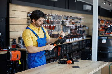 A man working on a grinding machine in a store