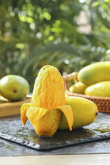 Fresh Ripe Mango with Golden Flesh Peeled and Ready to Eat with Tropical Fruits