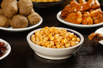 Chinese New Year Traditional Snacks with Walnuts and Preserved Foods in White Bowls