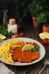 A Viennese schnizel with french fries	