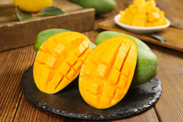 Fresh Ripe Mango Halves with Crosshatch Pattern on Slate Plate