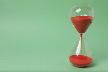 hourglass on a green background

