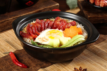 Cantonese Clay Pot Rice with Chinese Sausage and Egg in Traditional Black Casserole Bowl