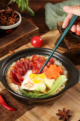 Cantonese Clay Pot Rice with Preserved Sausage and Fried Egg - Traditional Chinese Cuisine Specialties