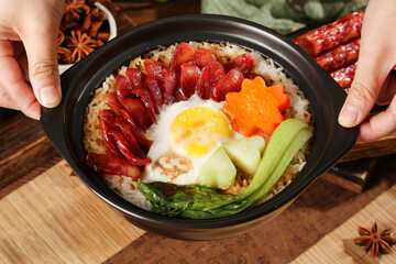Cantonese Style Clay Pot Rice with Bacon and Egg in Traditional Casserole Bowl