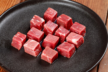 Raw Australian Beef Cubes Display on Black Plate Ready for Cooking