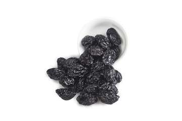 Dried Prunes from Xinjiang Spilling from White Bowl on White Background