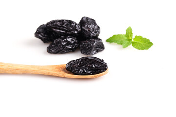Dried Xinjiang Prunes with Mint Leaves and Wooden Spoon on White Background