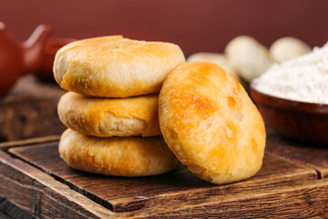 Traditional Cantonese Pastry Puffs Mooncakes on Wooden Board with Baking Ingredients