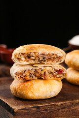 Traditional Cantonese Mooncakes with Mixed Nut Filling Cut in Half on Wooden Board