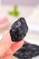 Large Xinjiang Dried Prune Held in Hand - Tempting Air-Dried Fruit Snack