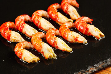 Freshly Cooked Crayfish with Red Shells and Yellow Tails on Dark Background
