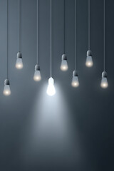 Modern pendant lights hanging in a minimalist setting, illuminating a dark background with ambiance