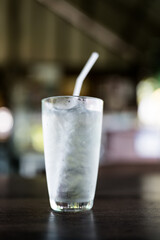 Transparent glass of water with ice cubes and a straw, refreshing drink cold beverage clear liquid hydration thirst quencher healthy