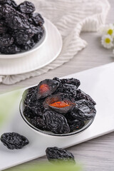 Air-dried Xinjiang Prunes in White Bowls - Traditional Chinese Dried Fruit on Wooden Background
