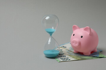 piggy bank, money dollars euros on a gray background
