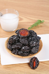 Dried Xinjiang Prunes in Wooden Bowl with Milk - Traditional Air-Dried Fruit Snack