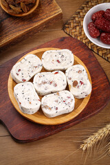 Homemade Nougat Candy with Nuts Seeds and Dried Fruits on Rustic Wood Table Healthy Snack Food