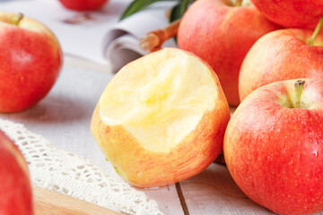 Fresh Red Fuji Apples with Peeled Apple on White Lace Cloth in Natural Light