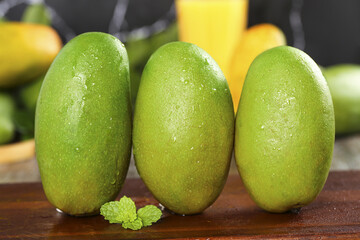 Fresh Green Mango Fruits with Water Drops on Wooden Table - Tropical Produce Display